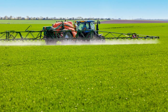 Conventional,Intensive,Agriculture,-,Spreading,Pesticide,On,A,Cereal,Field