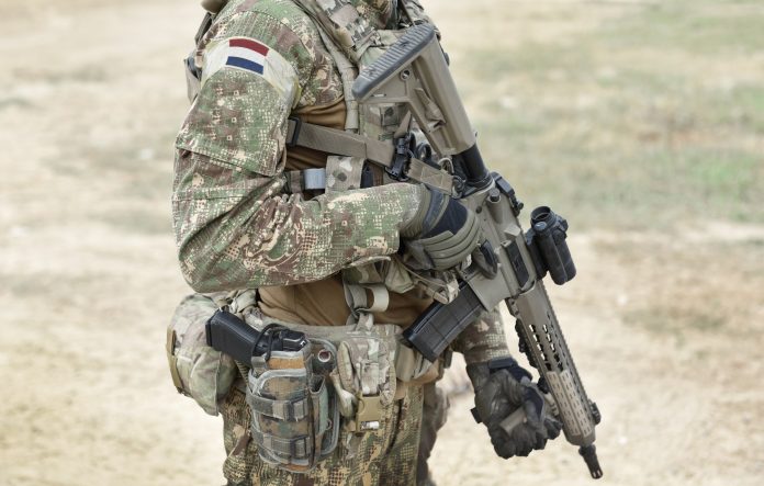 Soldier,With,Assault,Rifle,And,Flag,Of,Netherlands,On,Military